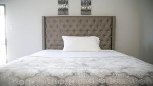 a bedroom with a bed with a large headboard at Ocean View Terrace in Montego Bay +35 photos