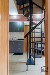 a kitchen with a spiral staircase in a room at Pokoje FreeDoor in Ługniany