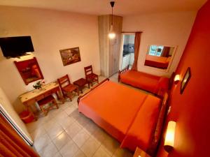 a bedroom with a bed and a table and chairs at Stelios Studios - Zante Seaview Nests in Tragaki