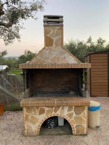 an outdoor pizza oven with a brick fireplace at Stelios Studios - Zante Seaview Nests in Tragaki +41 photos
