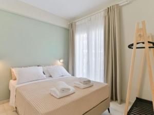 a bedroom with a bed with two towels on it at KaSta Family Apartments in Nikiti