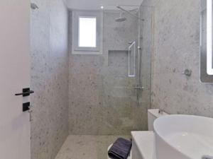a bathroom with a shower and a toilet and a sink at KaSta Family Apartments in Nikiti