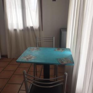 un tavolo blu e due sedie in una stanza di Aunaisin-Paz Centro-Vintage a Ushuaia