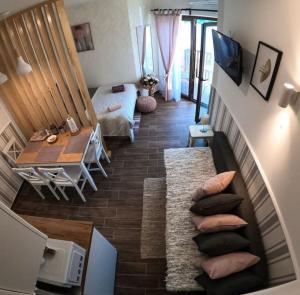 a living room with a stairway with pillows at Darja apartmani sa pogledom na jezero in Ostrovo