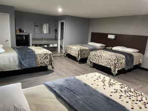 a hotel room with two beds and a bathroom at Ridge Motel in Breckenridge