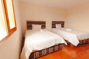 A bed or beds in a room at Los Ponchos Inn Apartotel