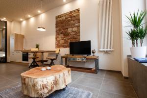 a living room with a wooden stump table and a television at Saargemünder 128 in Saarbrücken