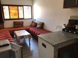 a living room with a couch and a table at Imsouane Sunrise Apartments in Imsouane