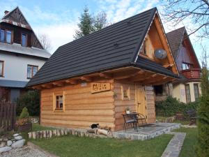 a log cabin with a black roof at Misia Chata in Zakopane