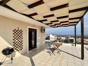 a balcony with a table and chairs on a roof at Sunrise Studio with unhindered view to the sea. in Nea Makri