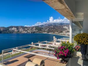 a balcony with a view of the water and mountains at La Herradura 3 bedroom apartment in La Herradura