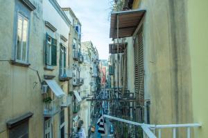 a view of an alley between two buildings at WANDERLUST NAPLES a place to stay in Naples