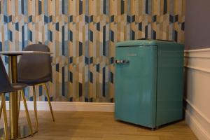 an old green refrigerator in a room with a wall at WANDERLUST NAPLES a place to stay in Naples