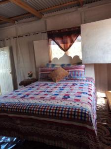 a bedroom with a bed with a colorful quilt at Relax N Sunshine 