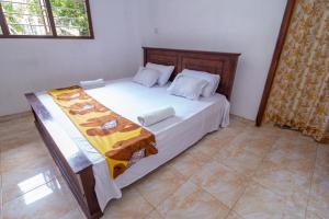 a bedroom with a large bed in a room at Mountain Gem Villa in Hikkaduwa