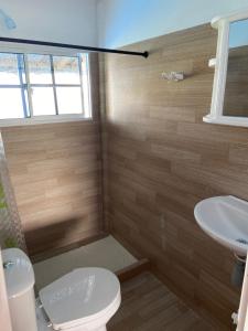 a bathroom with a toilet and a sink at Hotel Puntanorte in Tintipan Island