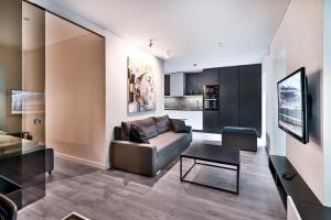 a living room with a couch and a table at Jacuzzi Cinema Loft in Kaunas +18 photos