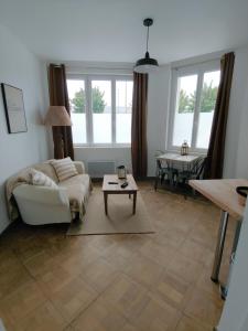 a living room with a couch and a table at LA BERGE in Amiens