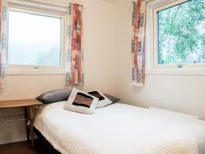 una camera con due letti e due finestre di 3 person holiday home in HEN N a Henån
