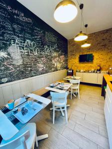 a restaurant with tables and chairs and a chalkboard wall at Il Covo degli Arditi B&B in Potenza