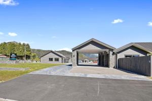 a driveway in front of a house with a garage at Grand Suites Murchison in Murchison