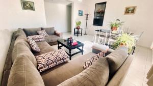 a living room with a couch and a table at Modern & Sunny new appartement 2 rooms in Rabat centre - Hay Riad in Rabat