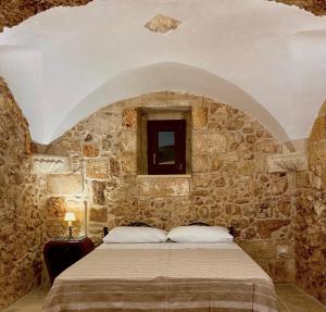 Postel nebo postele na pokoji v ubytování La Casetta di Nonna Elena