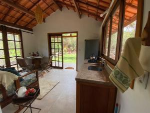 a kitchen with a sink and a counter top at Manacá Chalés do Vale in Vale do Capao