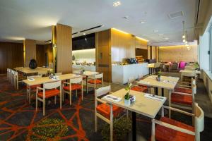 a restaurant with tables and chairs and a bar at Shangri-La The Marina, Cairns in Cairns