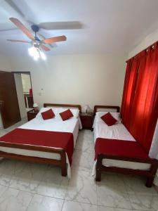 a bedroom with two beds and a ceiling fan at Departamento Urquiza in Salta