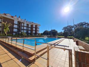 a swimming pool in front of a building at Noja. Piso en noja a 5 minutos de la playa de Ris in Noja