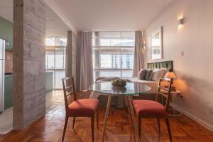 un salon avec une table, des chaises et un canapé dans l'établissement Vossa Bossa Copan, à São Paulo