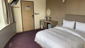 Postel nebo postele na pokoji v ubytování Michi Hotel - Luodong