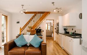 a living room with a couch and a kitchen at Holly Cottage, 2 bed house, sleeps 6 in Cleobury Mortimer