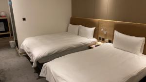 Postel nebo postele na pokoji v ubytování Michi Hotel - Luodong