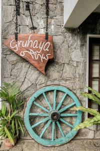 a sign on the side of a building with a wheel at Gruhaya Boutique Villa in Kandy