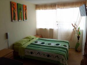 Postel nebo postele na pokoji v ubytování Hospedaje Kaihalulu