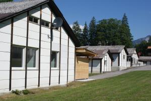 a row of houses in a row at Mountain Lodge Backpackercamp in Lenk