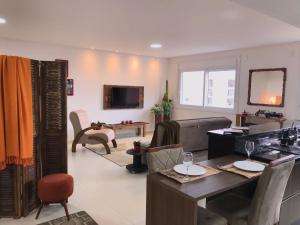 a living room with a couch and a table at RESIDENCIAL Montevidéu 805 in Osório