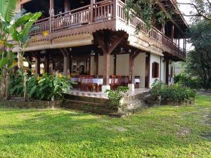 a house with a balcony on top of it at Sunbird Garden Resort in Sihanoukville