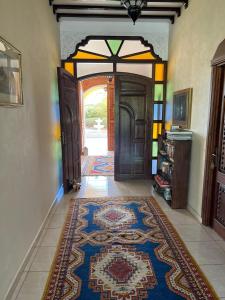 un corridoio con una porta con un tappeto sul pavimento di Riad TANJIL a Casablanca