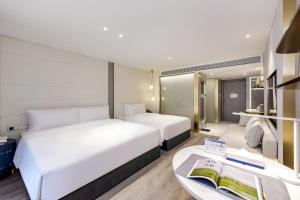 Postel nebo postele na pokoji v ubytování Kuanrong Suites Hotel Liangjiang love sea shopping park
