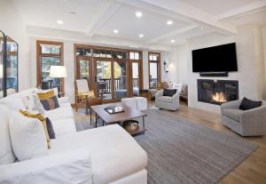 a living room with white furniture and a fireplace at Snowlcoud 203 condo in Avon