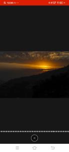 a picture of a sunset in the sky with clouds at 3 BHk Serviced Apartment I Open Air Lawn & Roof top I Bonfire I Nature Walk Kasauli By Exotic Stays in Kasauli