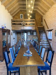 a large dining room with a long table and chairs at Elegant villa with jacuzzi near Možđenec in Možđenec