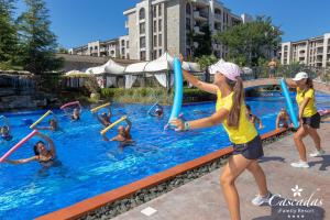 a group of people playing in a swimming pool at Cascadas Family Resort in Sunny Beach