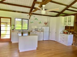 a kitchen with white appliances and a ceiling fan at Stay at the Barn... Immerse yourself in nature. in Kenilworth