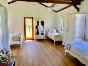 a bedroom with two beds and a mirror at Stay at the Barn... Immerse yourself in nature. in Kenilworth