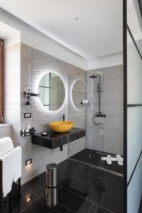 a bathroom with a sink and a mirror at Hotel Poerio 25 Boutique Stay in Naples