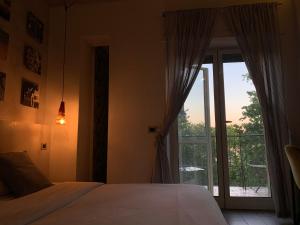 a bedroom with a bed and a window with a balcony at Stileroma in Rome